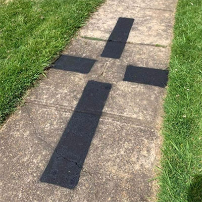 Photo control mark on a footpath.